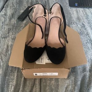 Slightly used black suede shoe